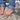Bare feet balancing on a large rock, with jeans rolled at the ankles