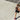 Woman running across a sunny paved boardwalk