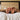Bare feet sticking out from under a blanket at the end of a bed